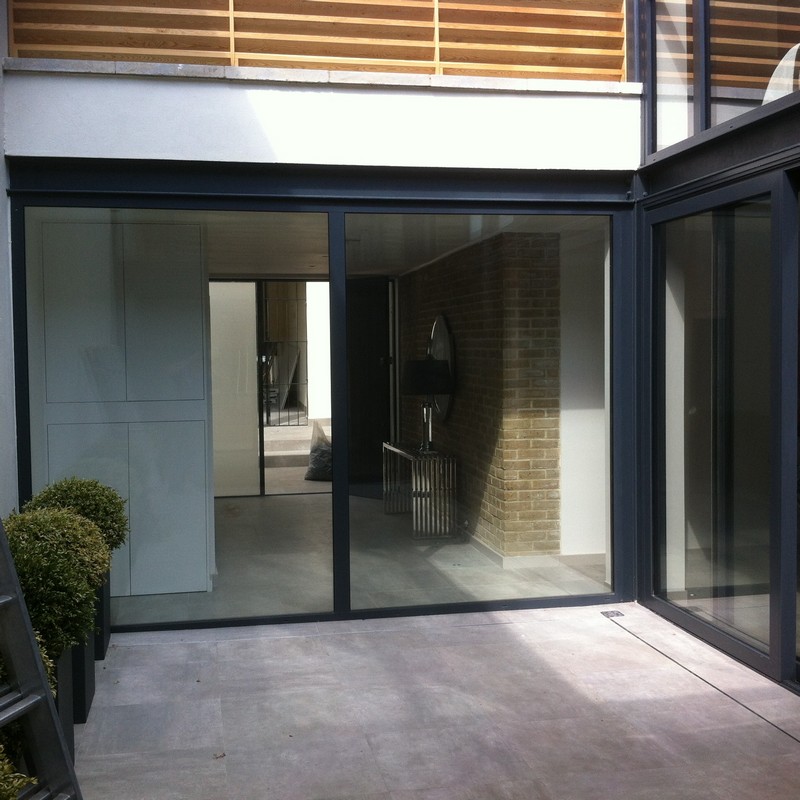 Floor-to-ceiling sliding doors opening to courtyard in Penge
