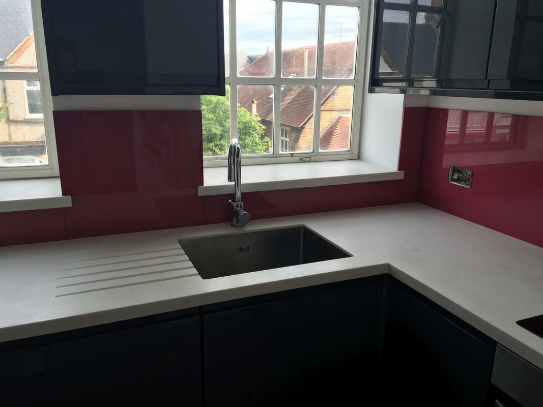 Deep plum coloured glass splashback in modern Penge kitchen